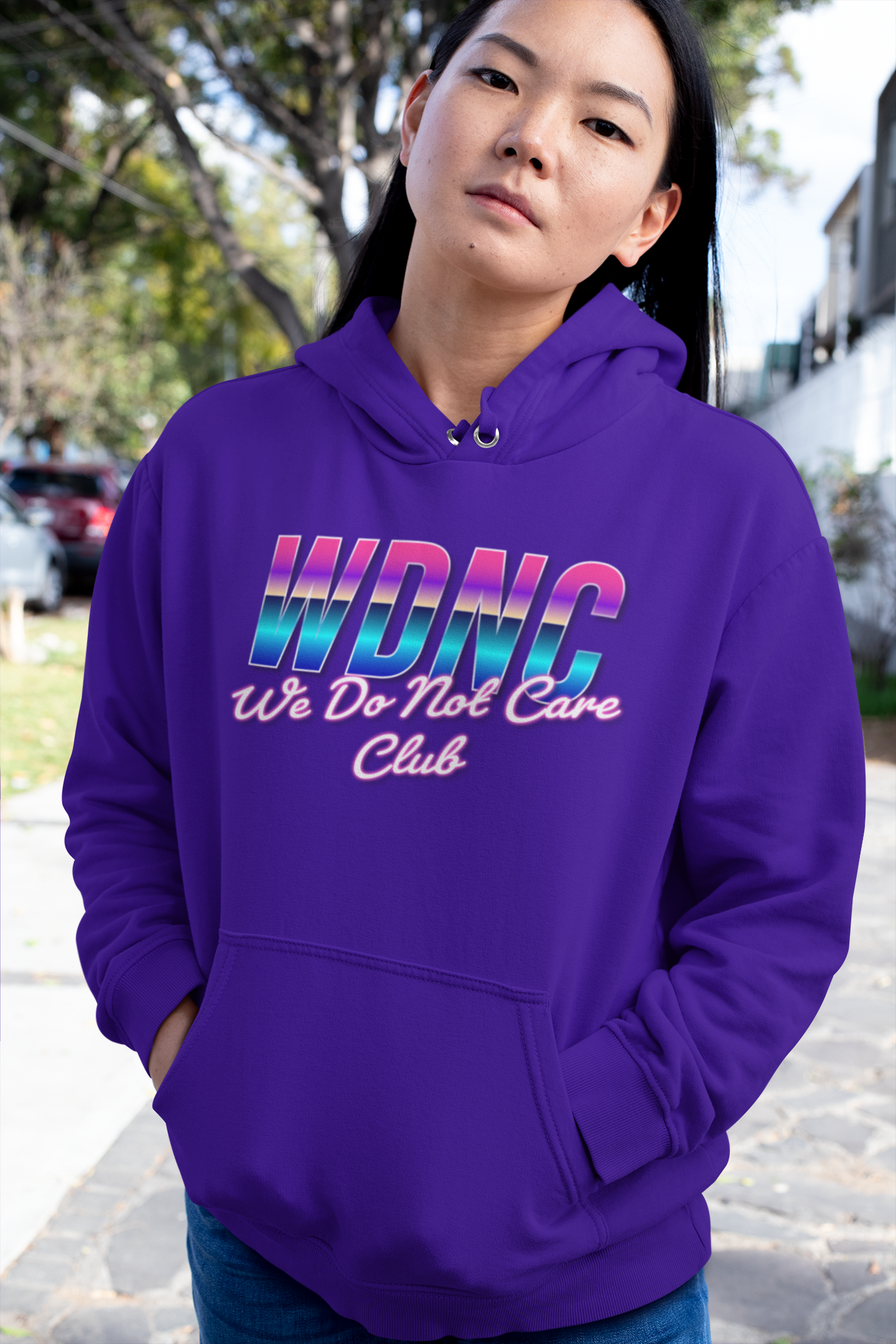 Person wearing a purple WDNC hoodie with colorful text in an outdoor setting